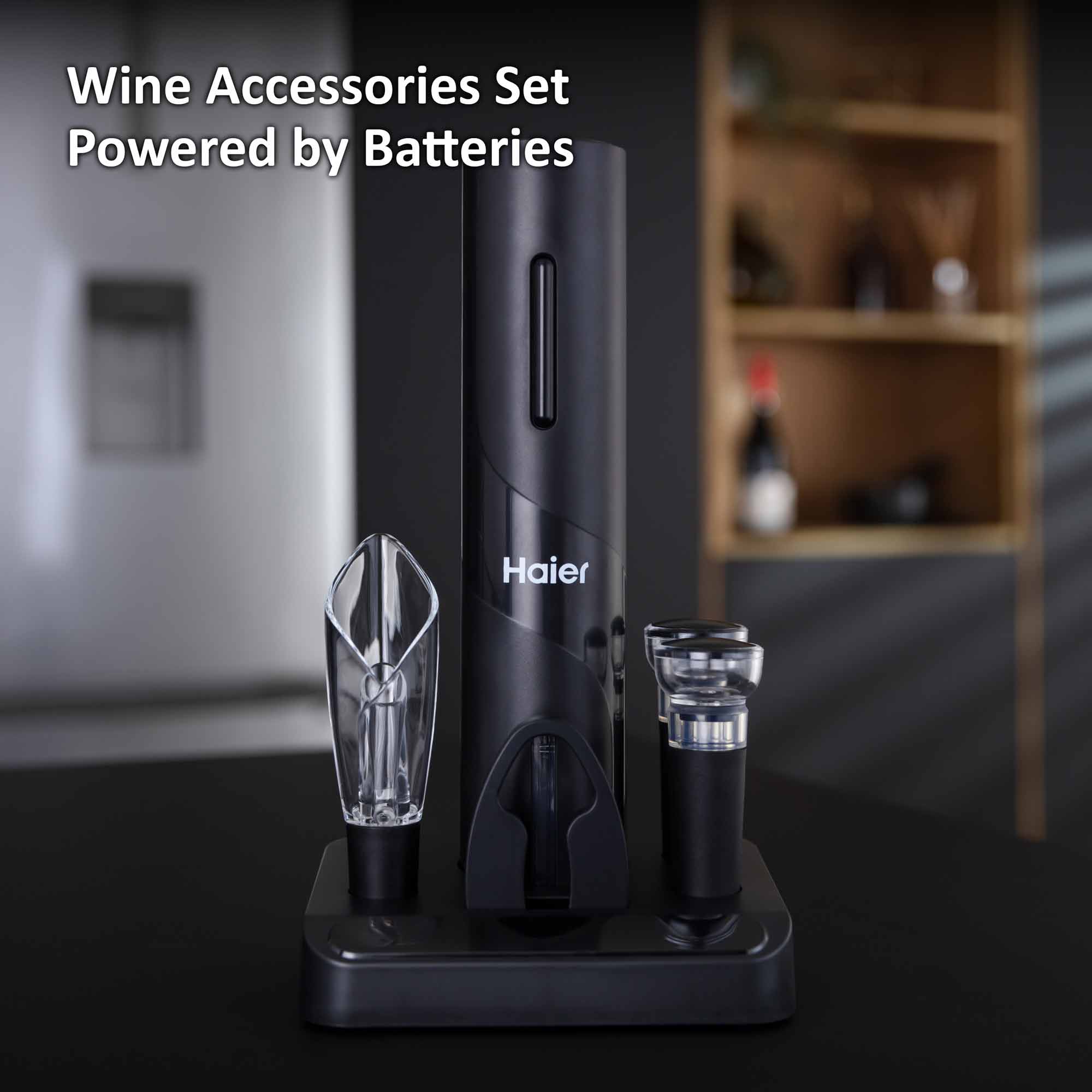 A sleek black wine accessory set, featuring an electric opener and aerator, stands on a kitchen counter. Text reads "Wine Accessories Set Powered by Batteries." A modern kitchen scene is in the background.