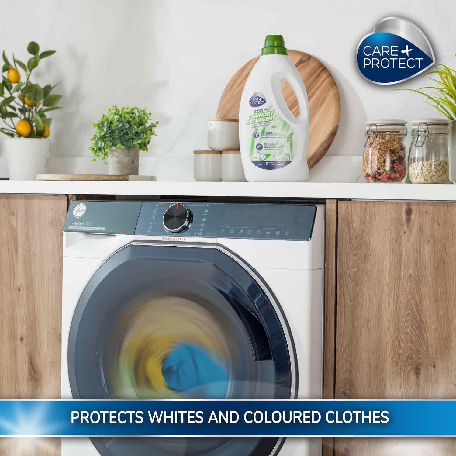 Washing machine spinning clothes swiftly in a modern kitchen, featuring a bottle of Eco Laundry Detergent on the counter. Text reads: "PROTECTS WHITES AND COLOURED CLOTHES."