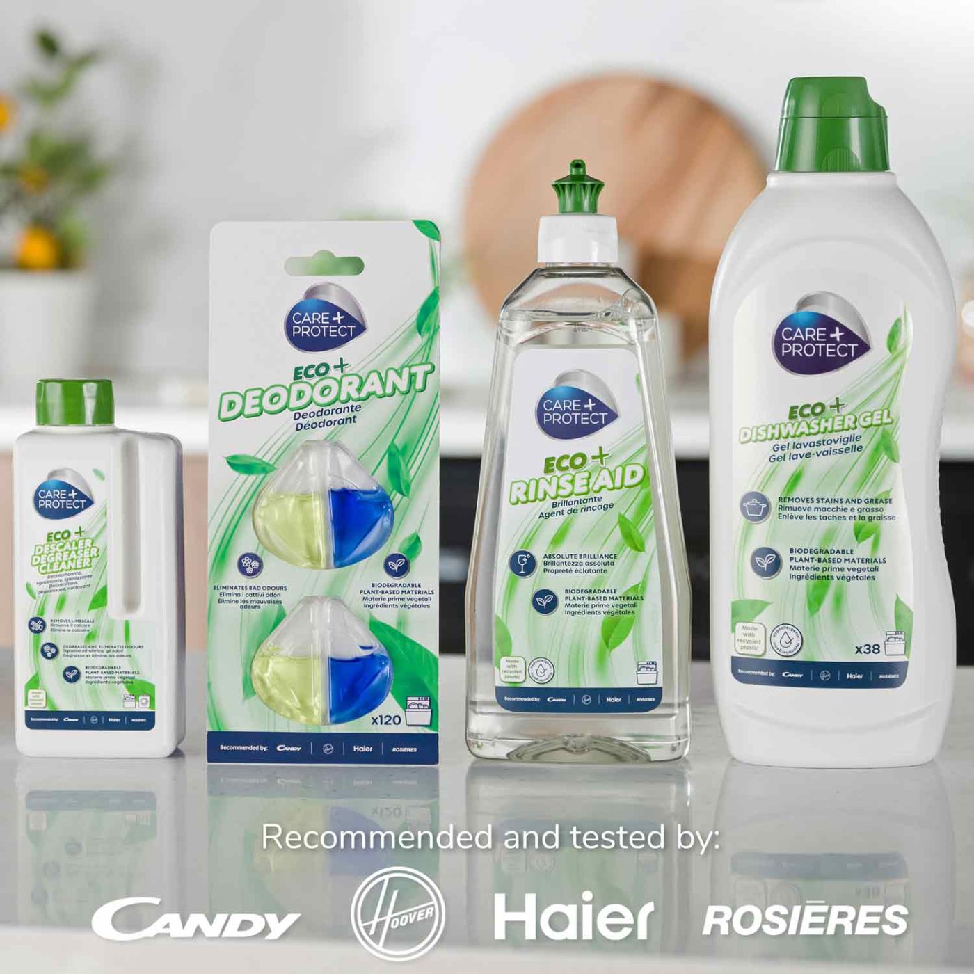 Bottles and packaging of CARE+PROTECT cleaning products stand on a countertop. Varieties include "Eco+ Descaler Cleaner," "Eco+ Deodorant," "Eco+ Rinse Aid," and "Eco+ Dishwasher Gel." Recommended by Candy, Hoover, Haier, Rosières.