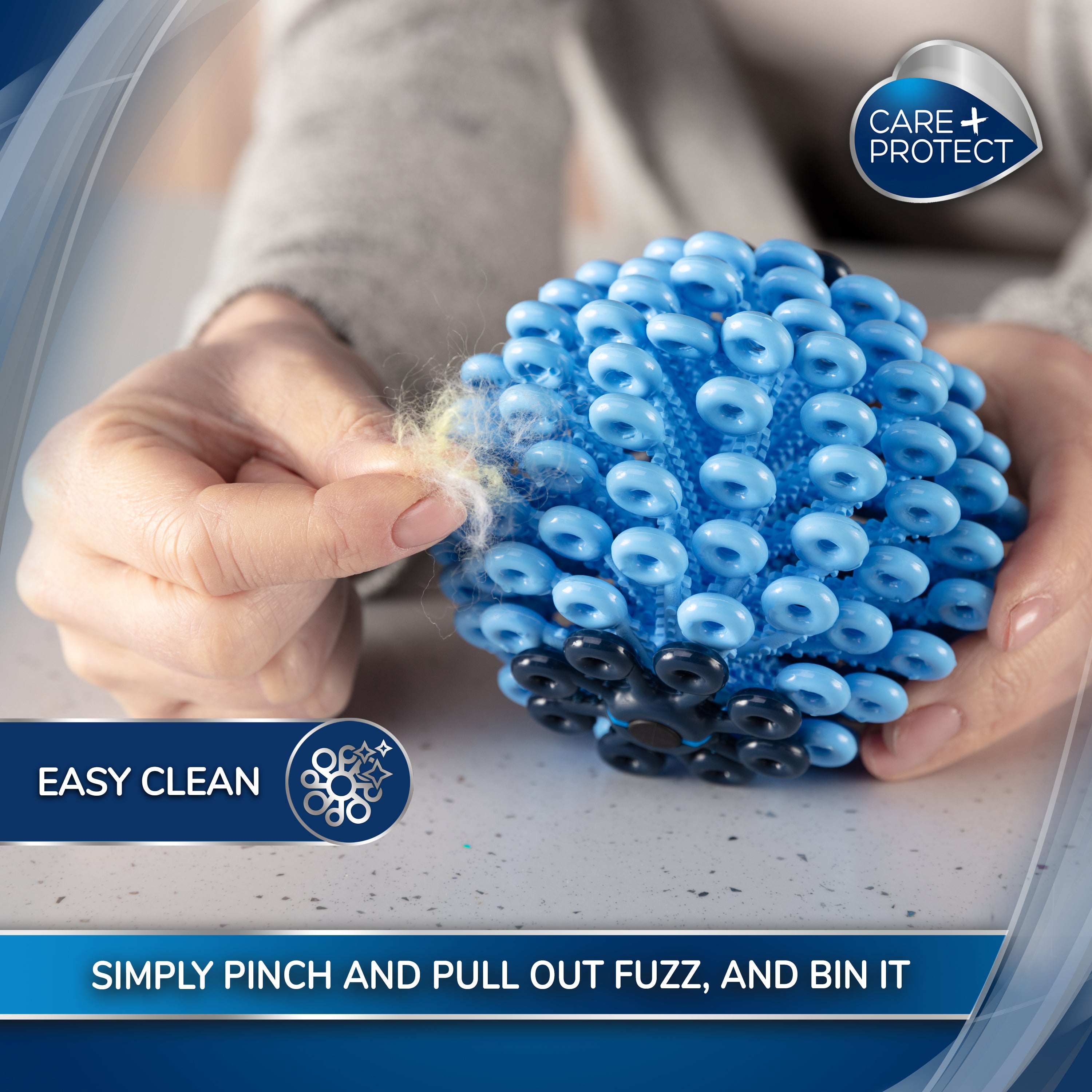 A hand removes fuzz from a blue, spherical, spiky cleaning tool on a speckled surface. Text: "EASY CLEAN," "SIMPLY PINCH AND PULL OUT FUZZ, AND BIN IT." Logo: “CARE+PROTECT.”