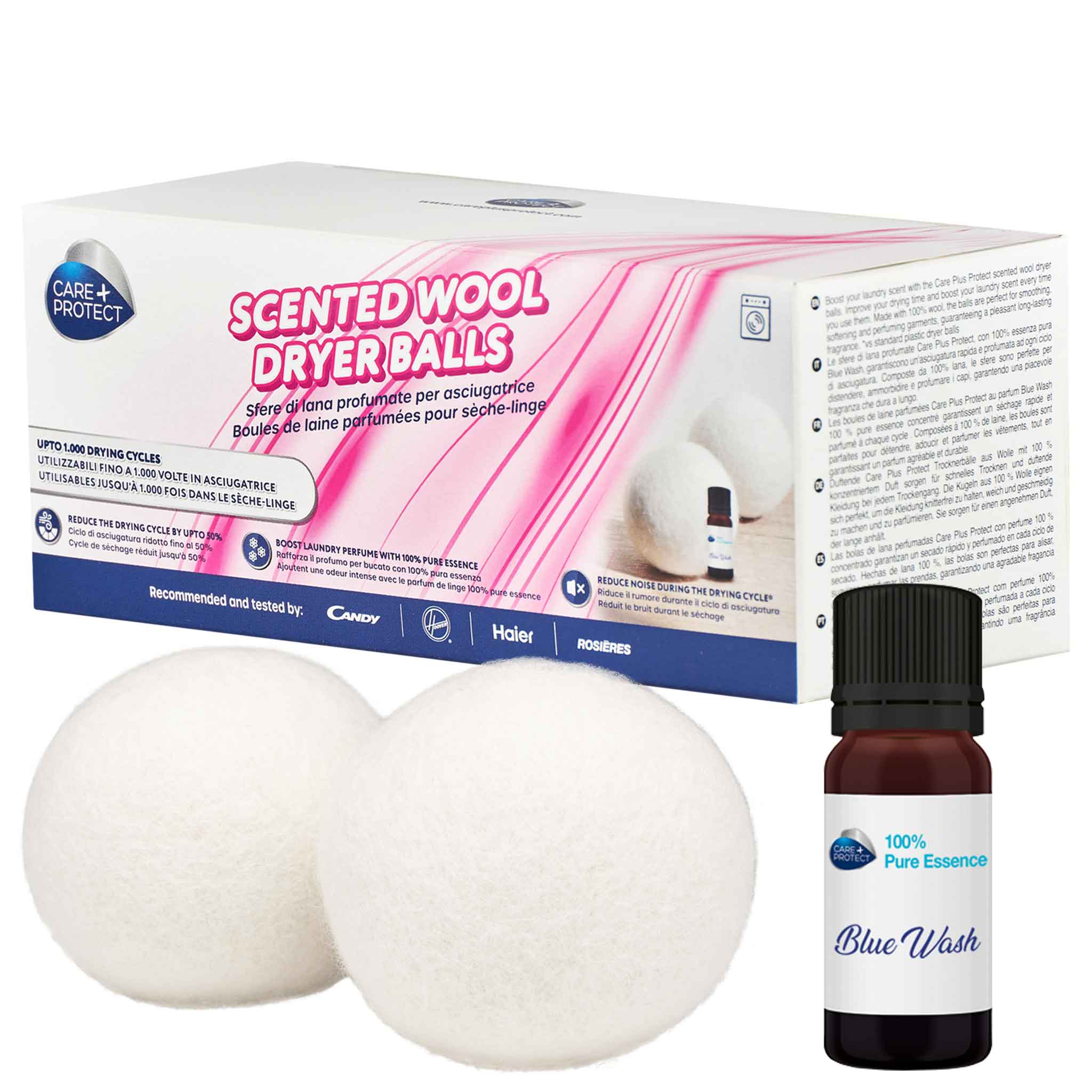 Two white scented wool dryer balls and a small brown bottle labeled "100% Pure Essence Blue Wash" are placed beside a box in a laundry context. Text includes "SCENTED WOOL DRYER BALLS," "UP TO 1,000 DRYING CYCLES," "BOOST LAUNDRY PERFUME WITH 100% PURE ESSENCE," and branding items like "CARE + PROTECT."