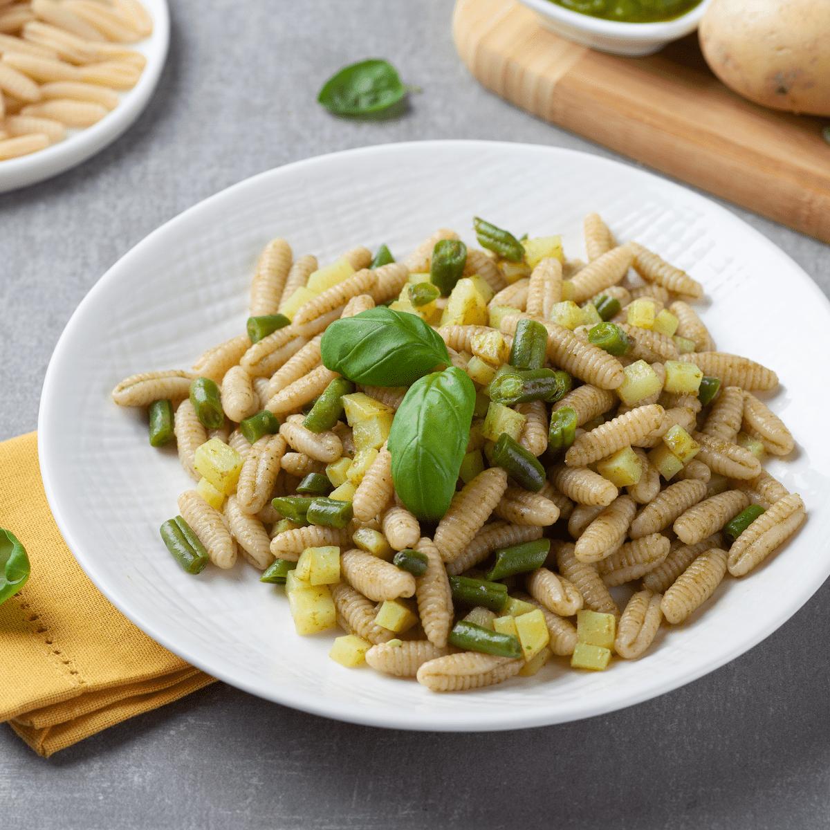 Pasta in pesto sauce with green beans and potato