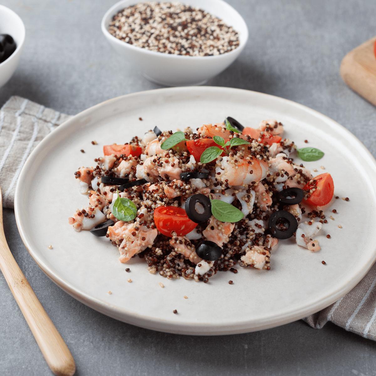 Mixed fish with quinoa, tomato and olives